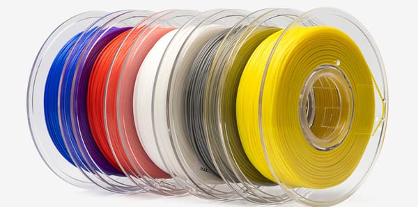 Spools of multicolored 3D printer filaments.